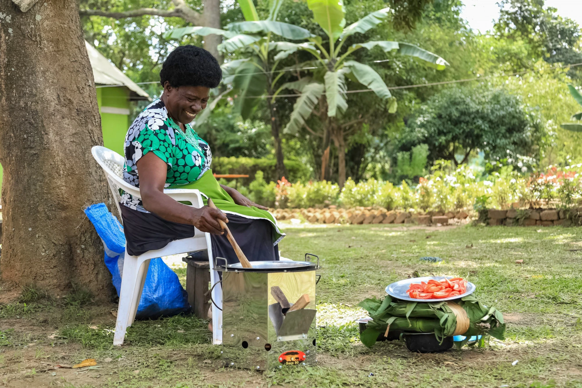 A Ugandan woman cooking with the Save 80 stove