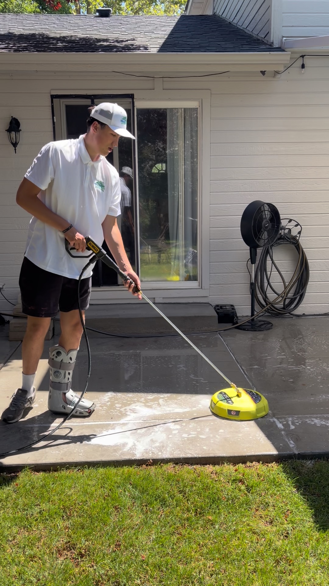 Daiken pressure washing a concrete back patio in the Treasure Valley