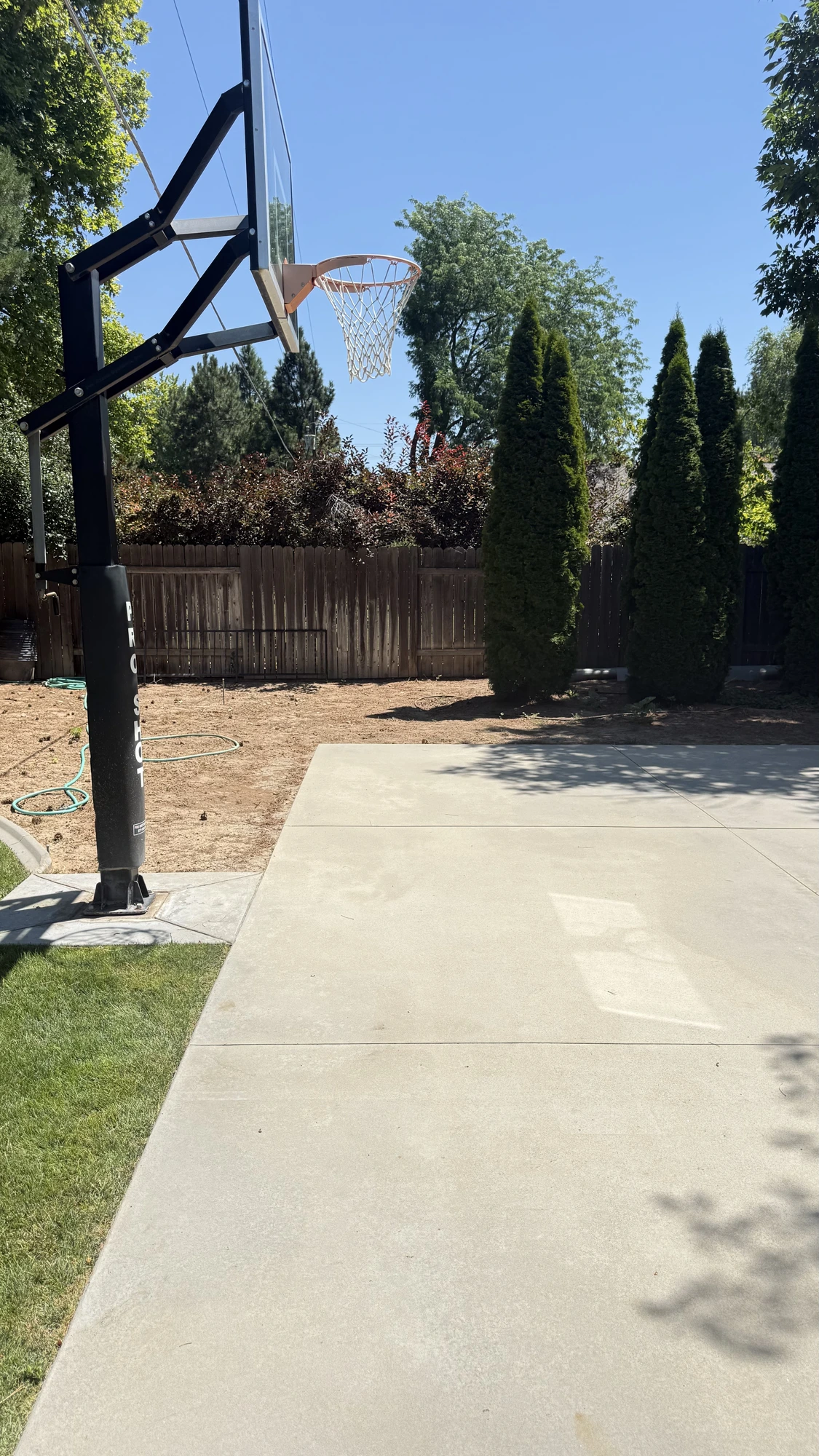 Backyard basketball court concrete before and after pressure washing in the Treasure Valley