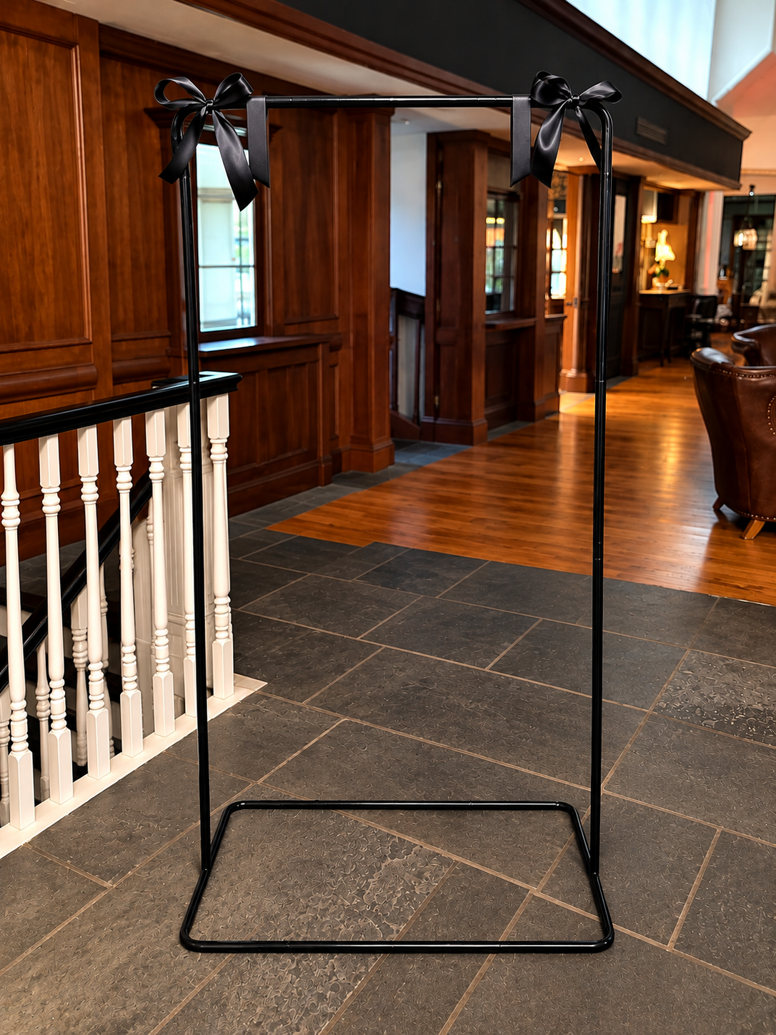 Black welcome sign stand styled with a wedding welcome sign