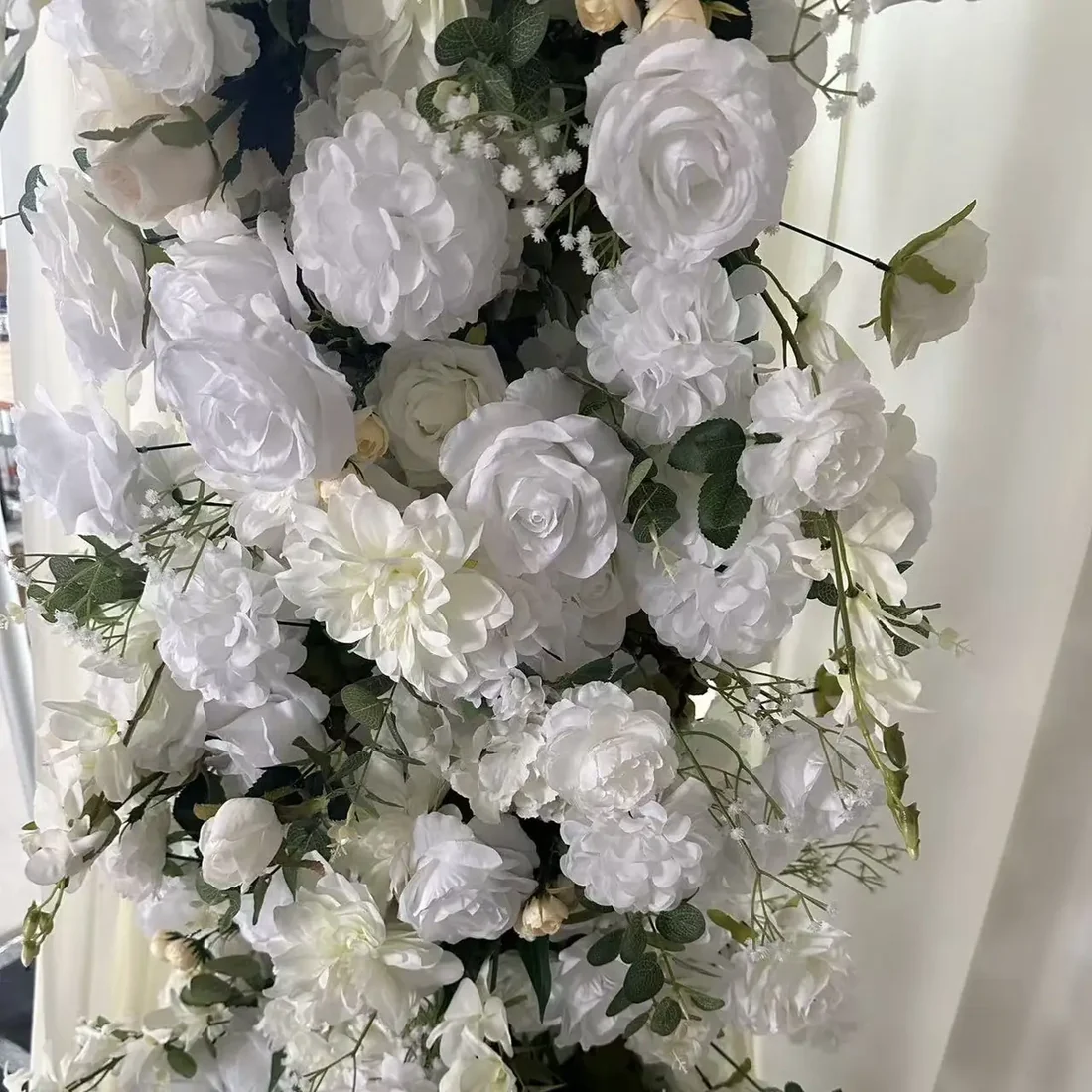 Close-up of the white rose and greenery floral detail