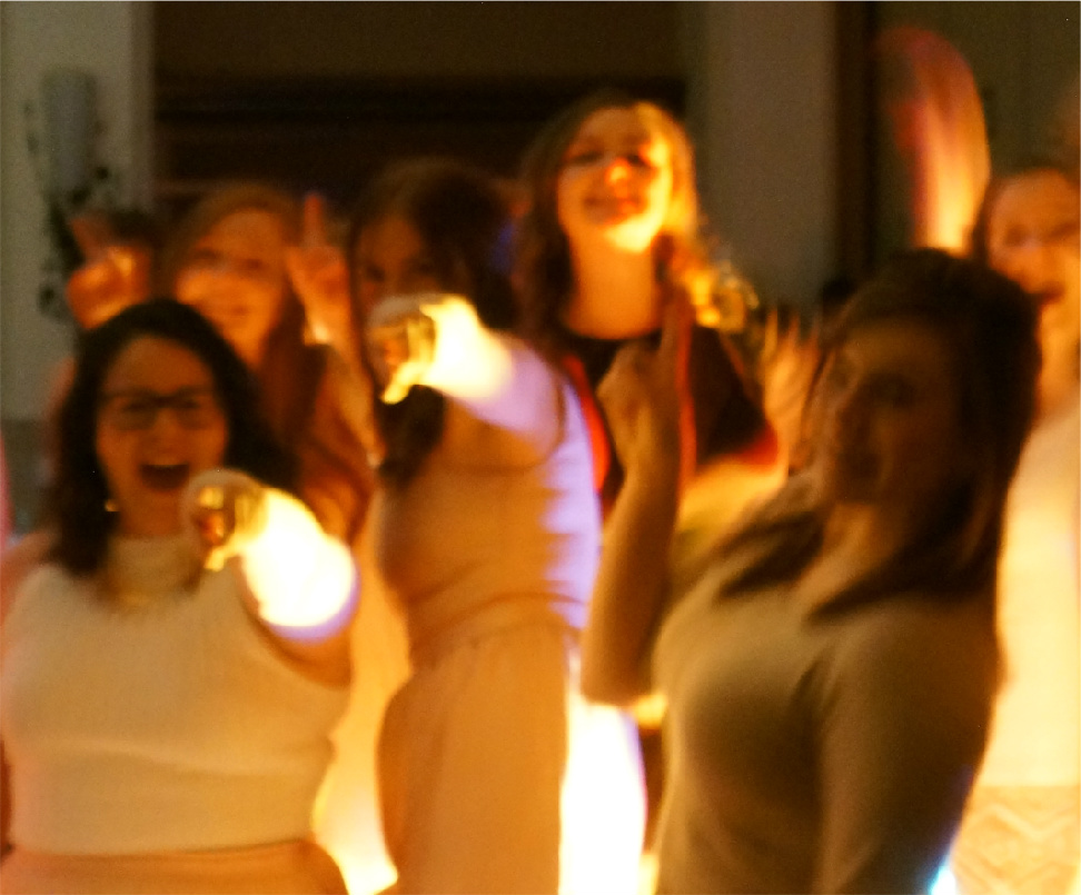 Happy guests singing and dancing at a DJ Eddie Black event — smiling ladies on the dance floor