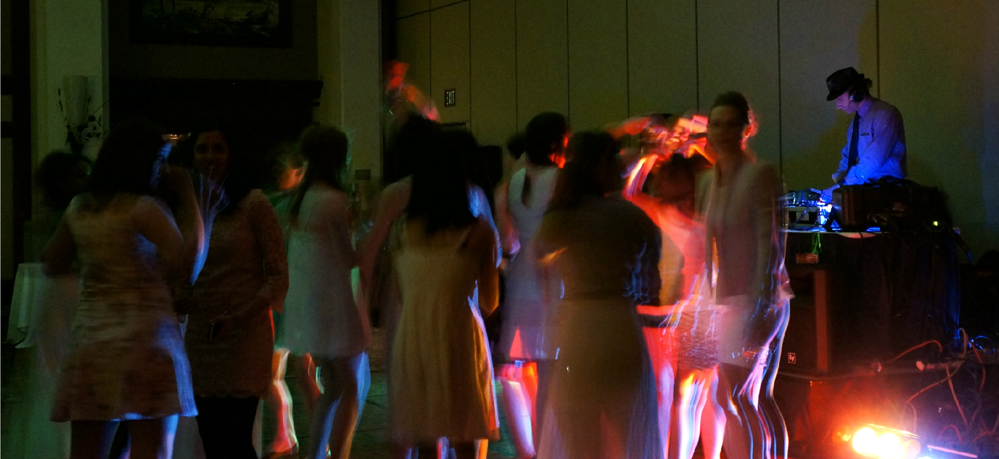 Packed dance floor lit by DJ Eddie Black's stage lighting — Alberta wedding reception with guests dancing