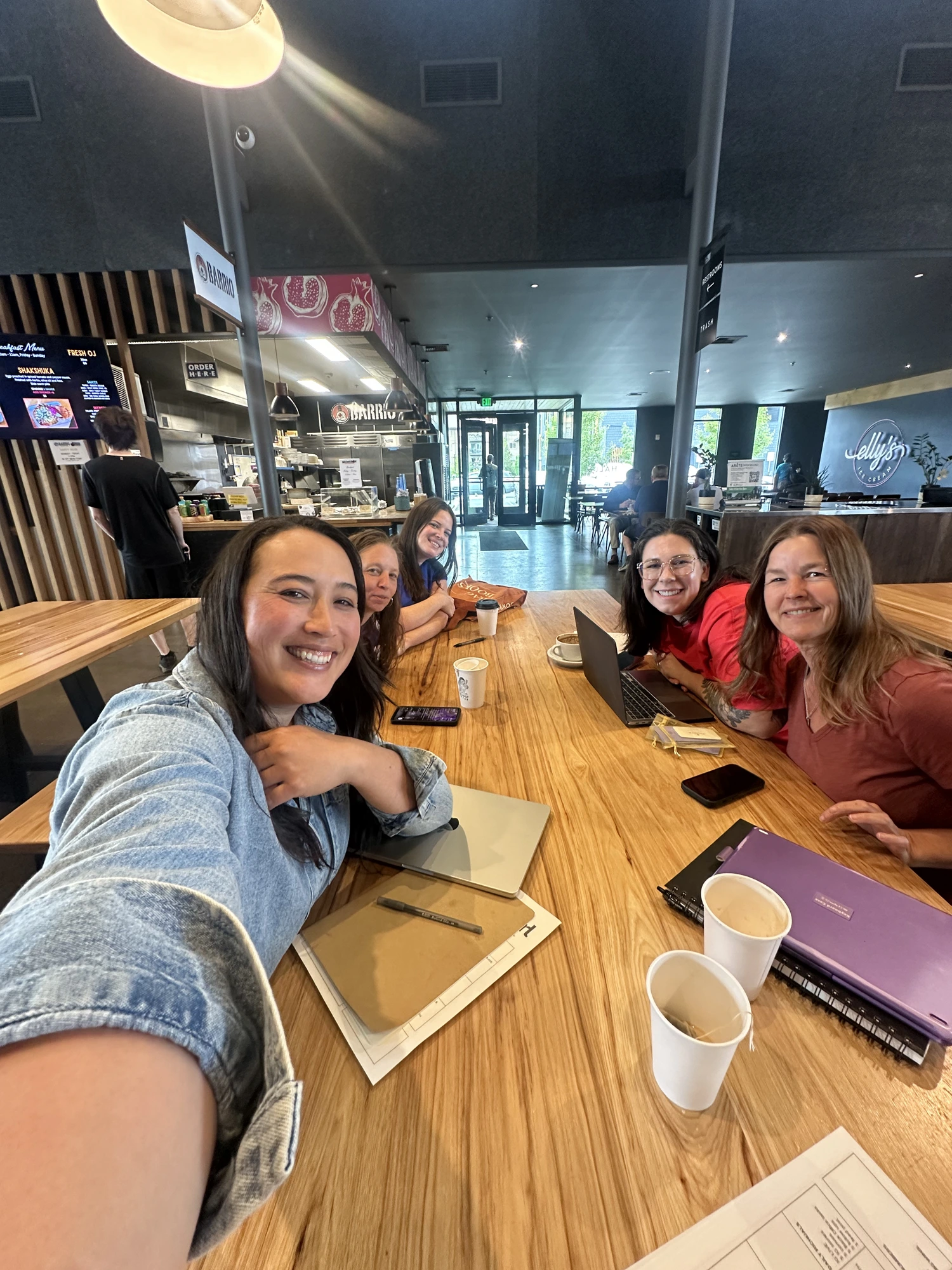 Women gathered around a table working together at Thump at The Grove
