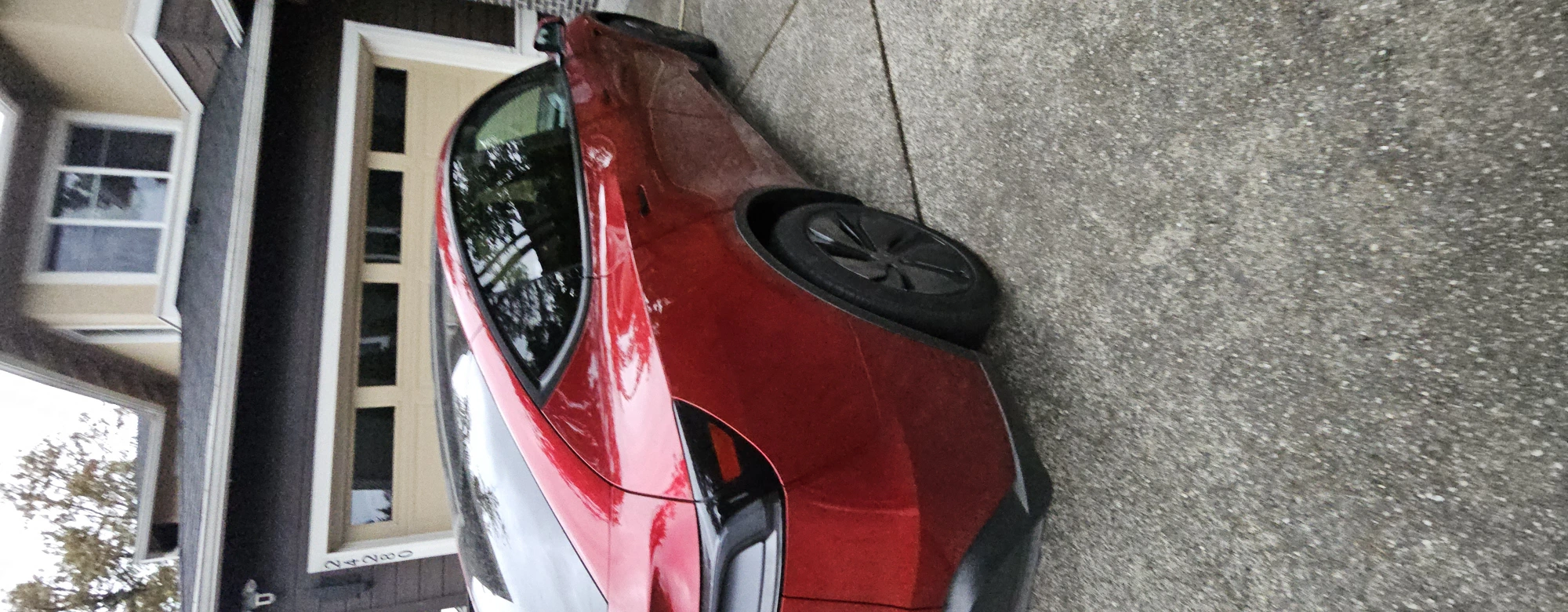 Red Tesla Model Y with doors open, cabin detailed by Pep
