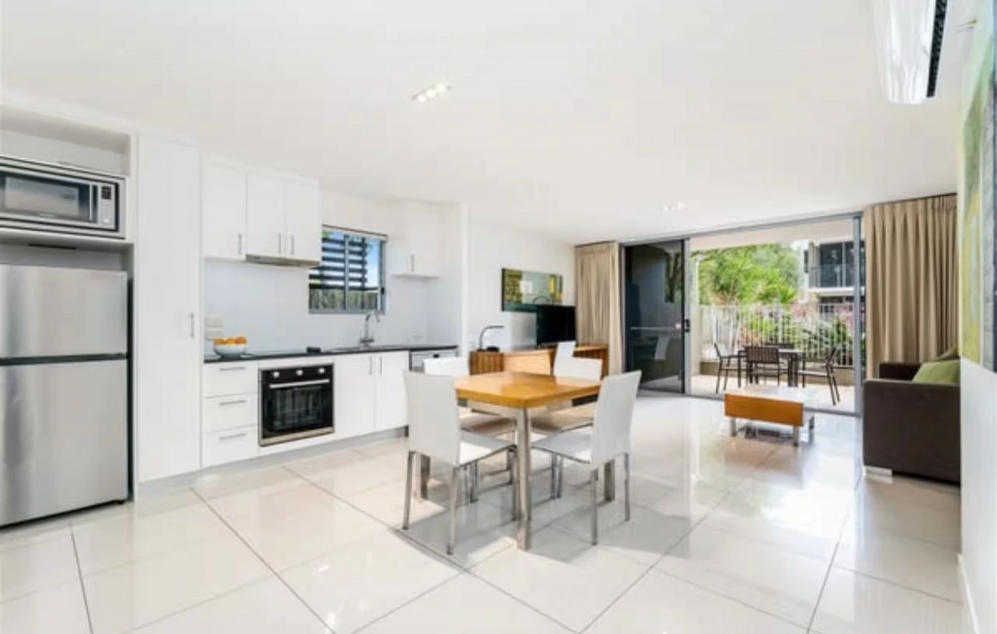 Living area opening to the terrace at Migaloo, Ramada Resort Urangan, Hervey Bay — photo 3 of 8