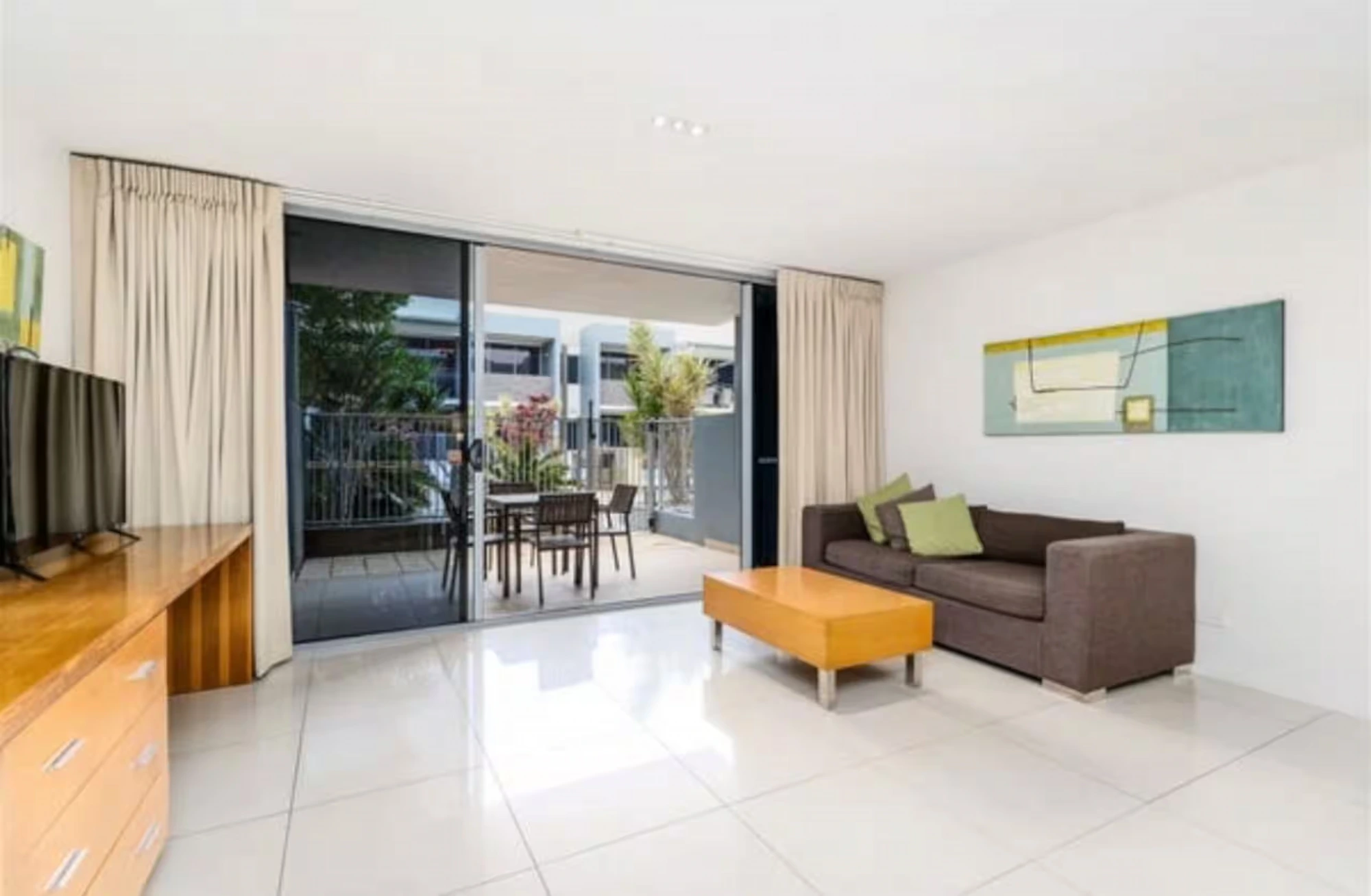 Living area opening to the terrace at Migaloo, Ramada Resort Urangan, Hervey Bay