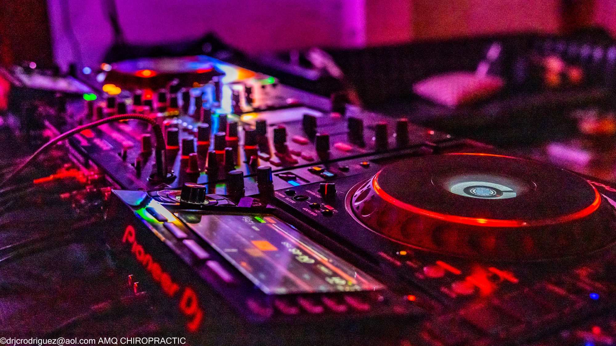 DJ performing under red lights